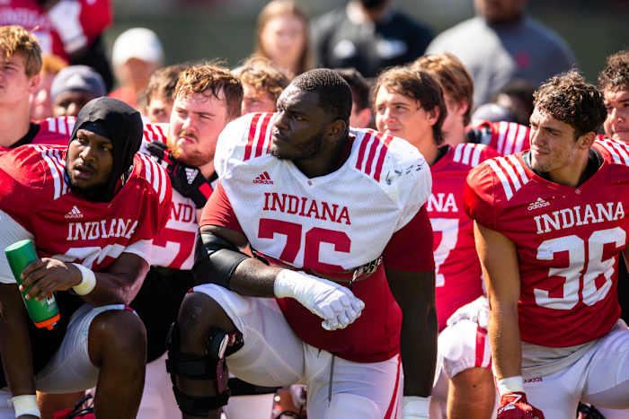 Matthew Bedford kneels alongside his teammates after practice.